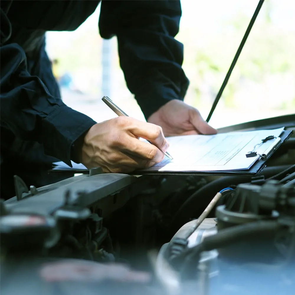 Mechanic servicing a car for MOT